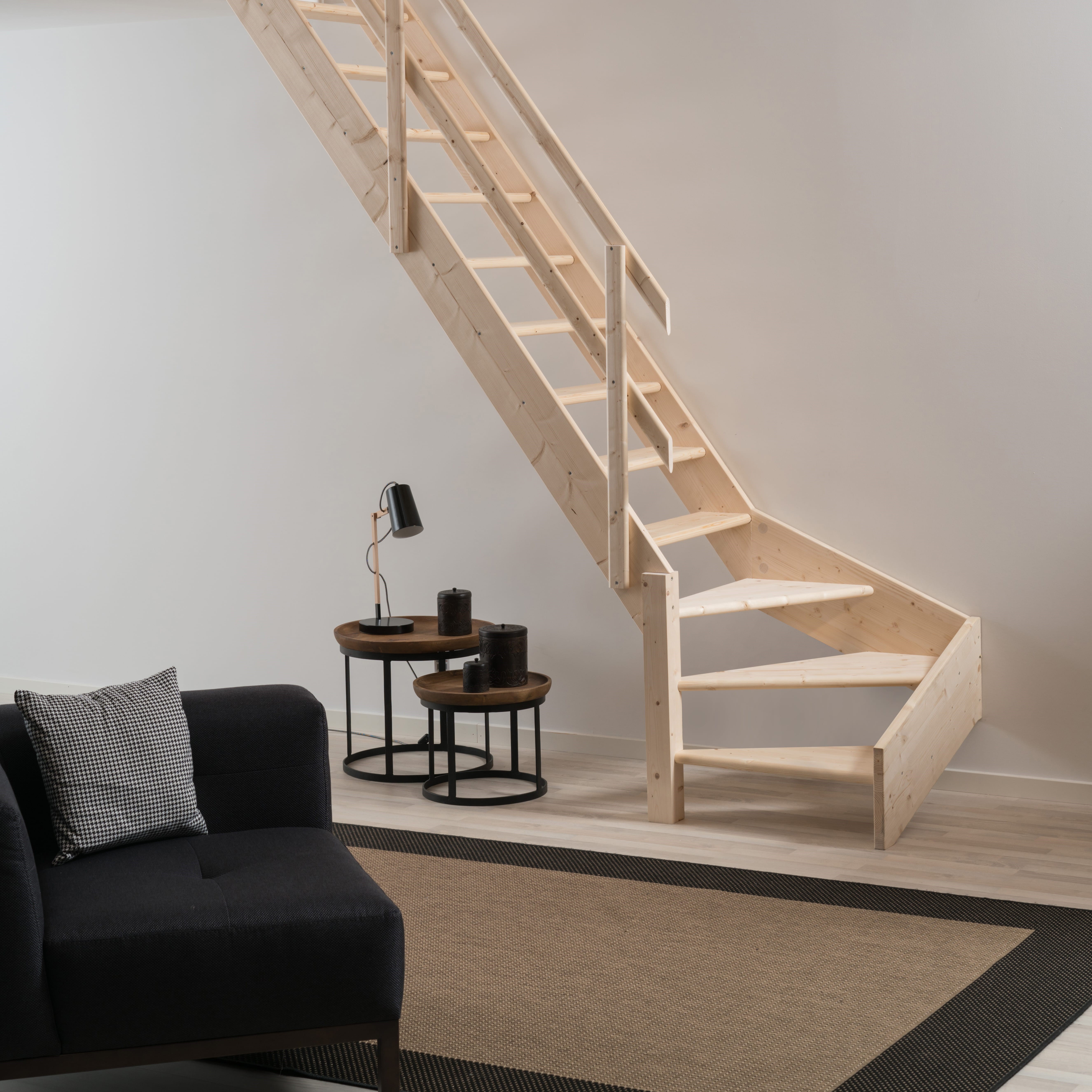 Minimalist wooden staircase NORMANDIE with clean lines in a modern, light-filled living area.