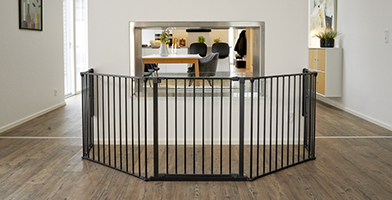 Secure indoor setup with a black safety gate enclosing a designated area, ideal for children or pets