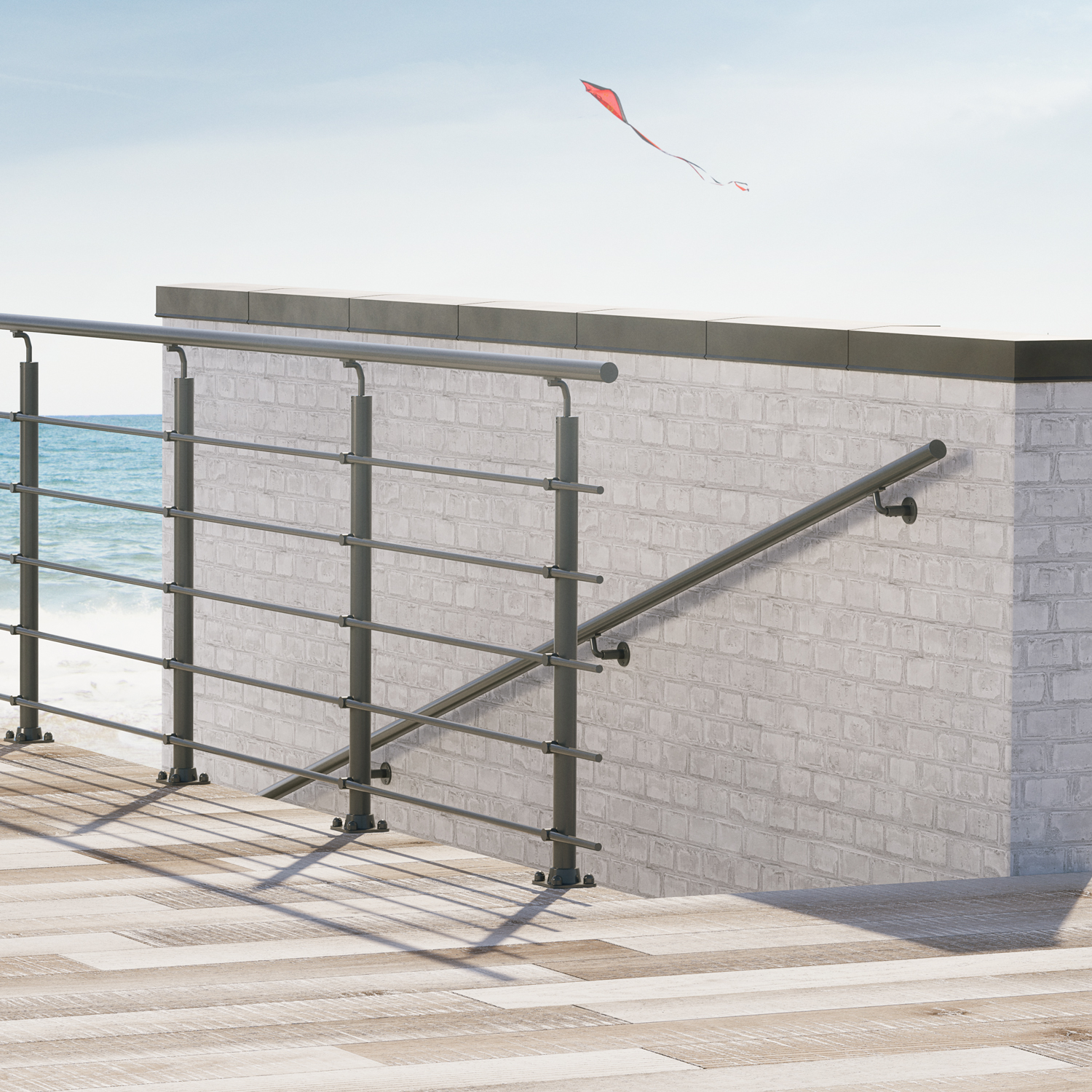 Metal handrail and railing on a seaside deck with white brick walls, overlooking the ocean with a kite flying in the background.