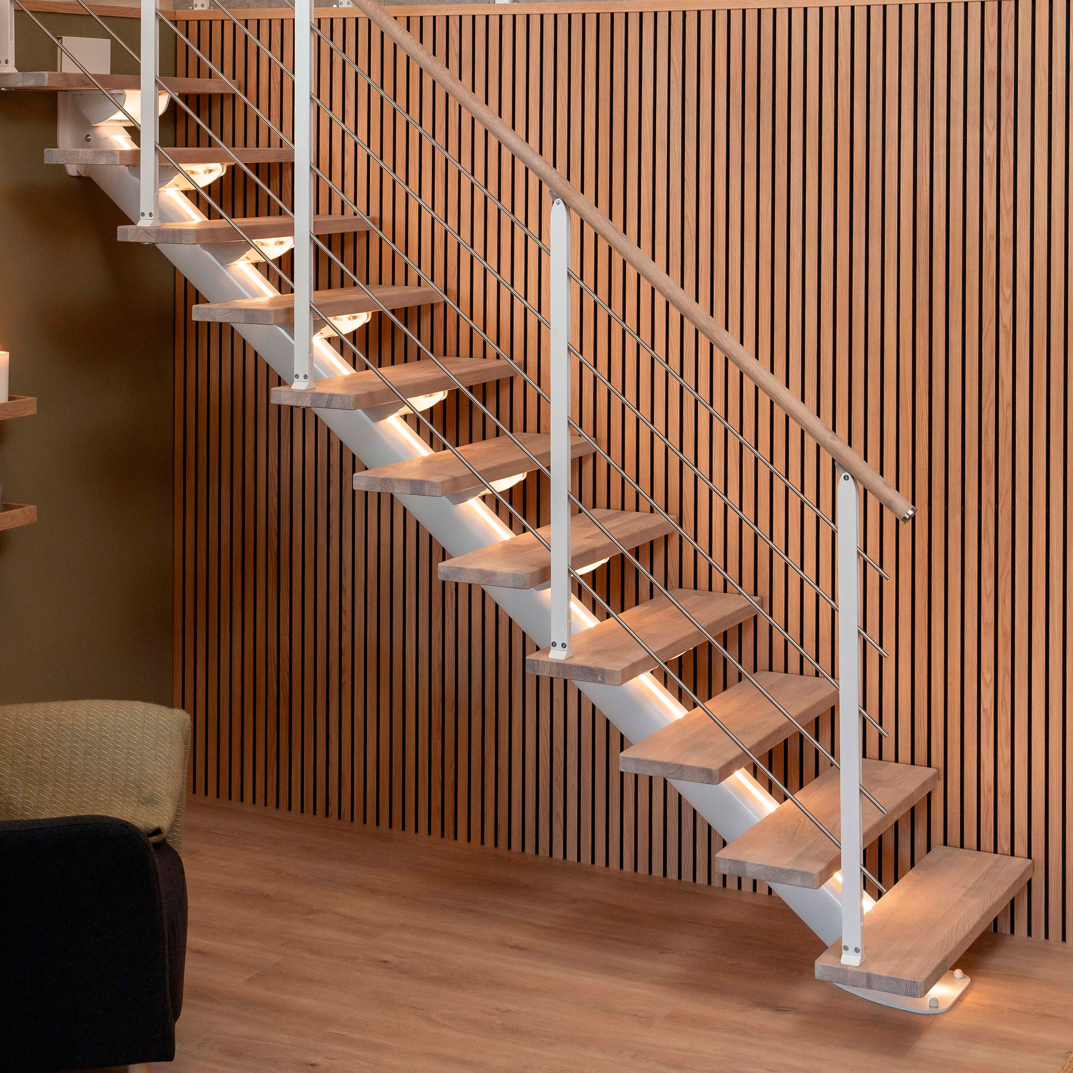 SYDNEY staircase with wooden treads, metal rails, and warm ambient lighting against a wood-paneled wall.