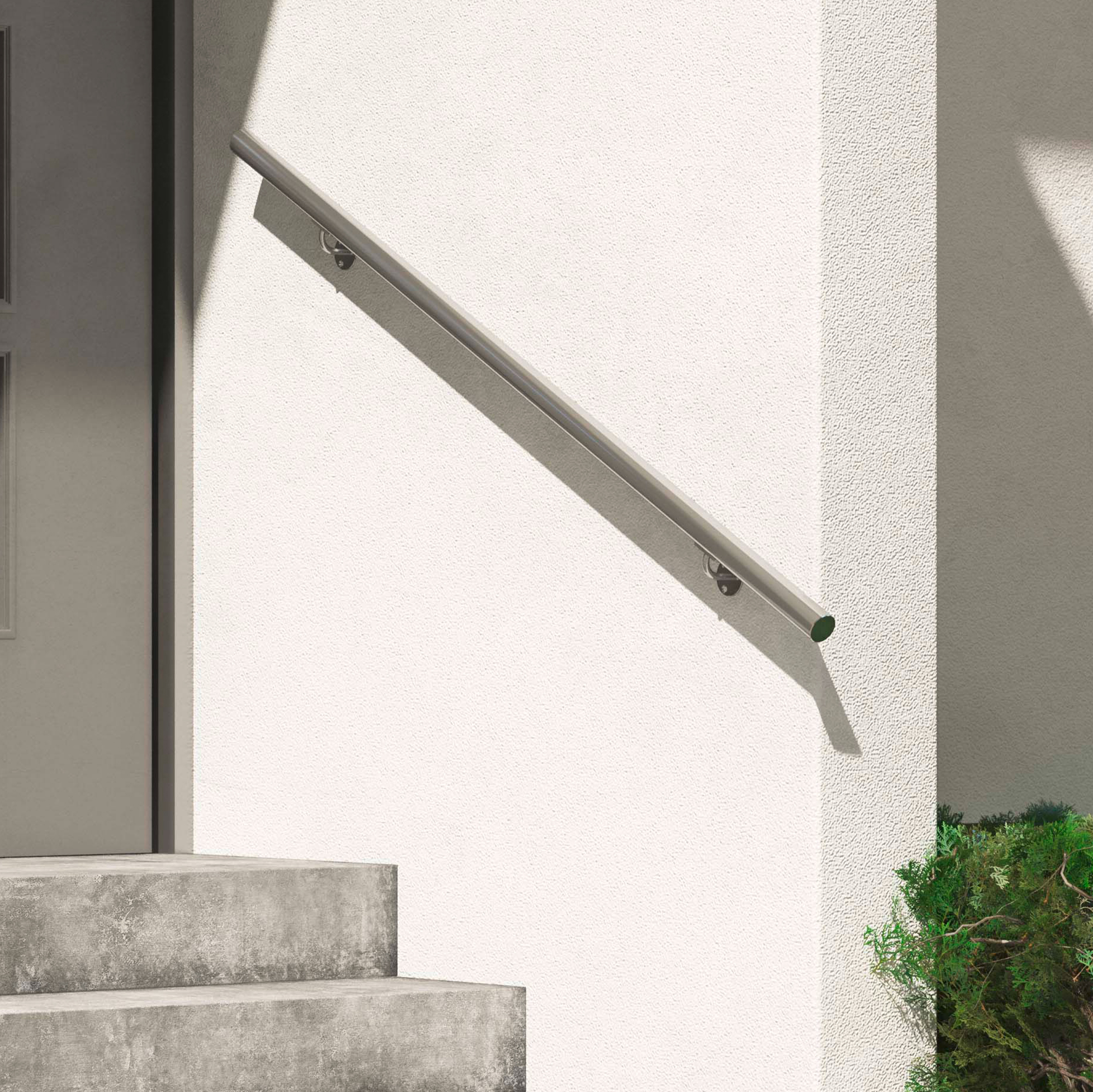 Minimalist wall-mounted metal handrail on a white exterior wall, next to concrete steps and greenery.